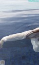 A woman in a white dress floating in a pool.