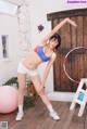 A woman in a blue and red bikini with a hula hoop.