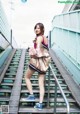 A woman is standing on a set of stairs.