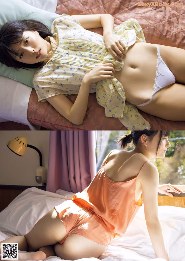 A woman laying on top of a bed next to a lamp.