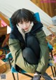 A woman sitting in a chair in front of a tent.