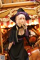 A woman dressed as a witch on a carousel.